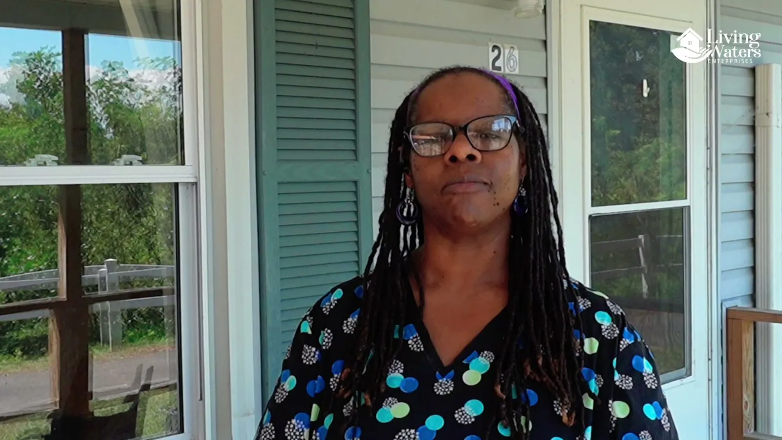 Sherry, one of the two members of staff in the film, on the porch of one of the houses.
